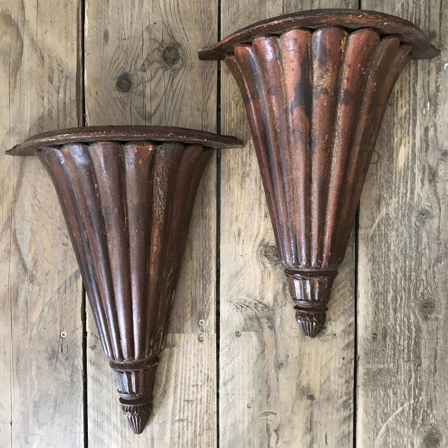 A pair of decorative fluted shelf brackets