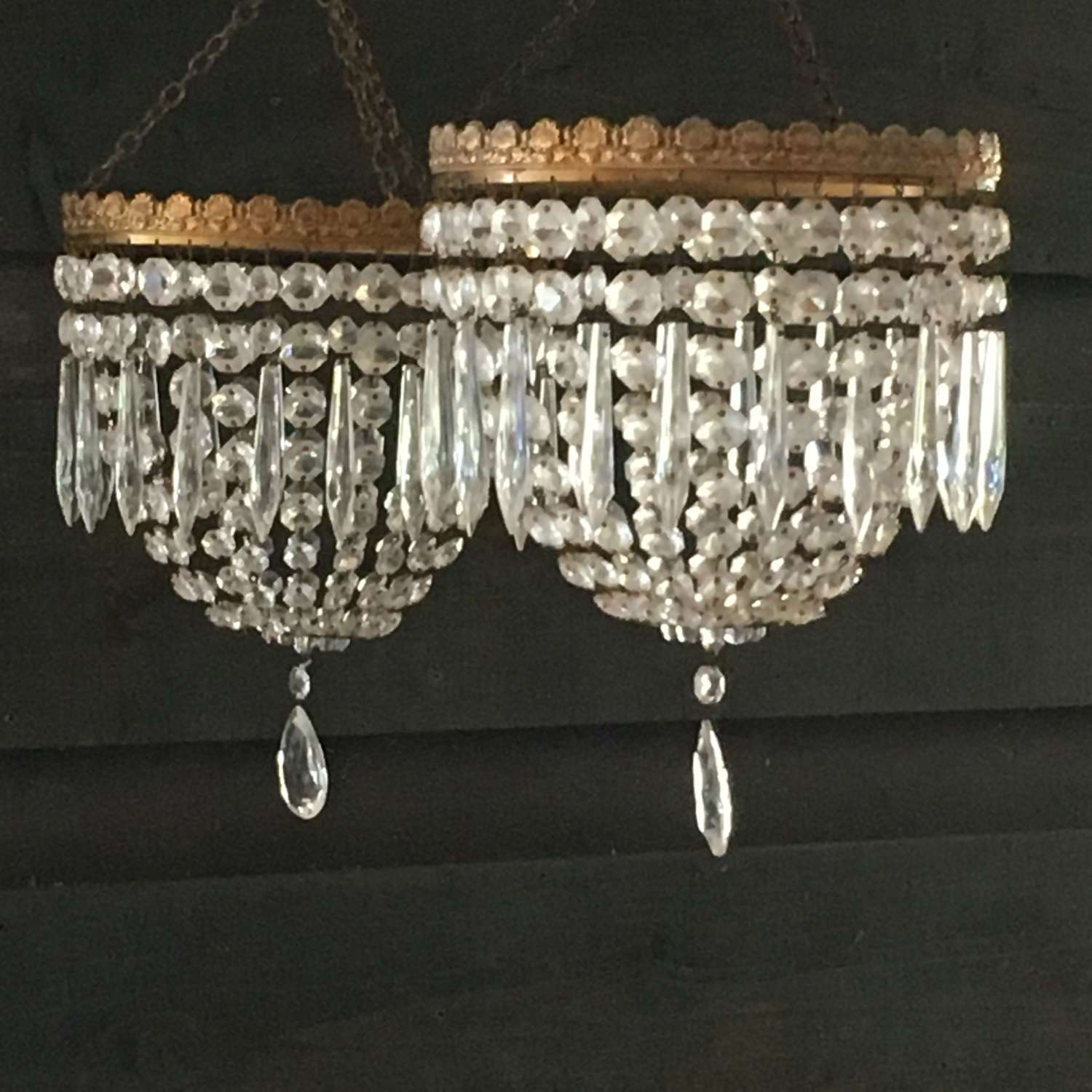A pair of crystal chandelier light shades on gilt hoops.