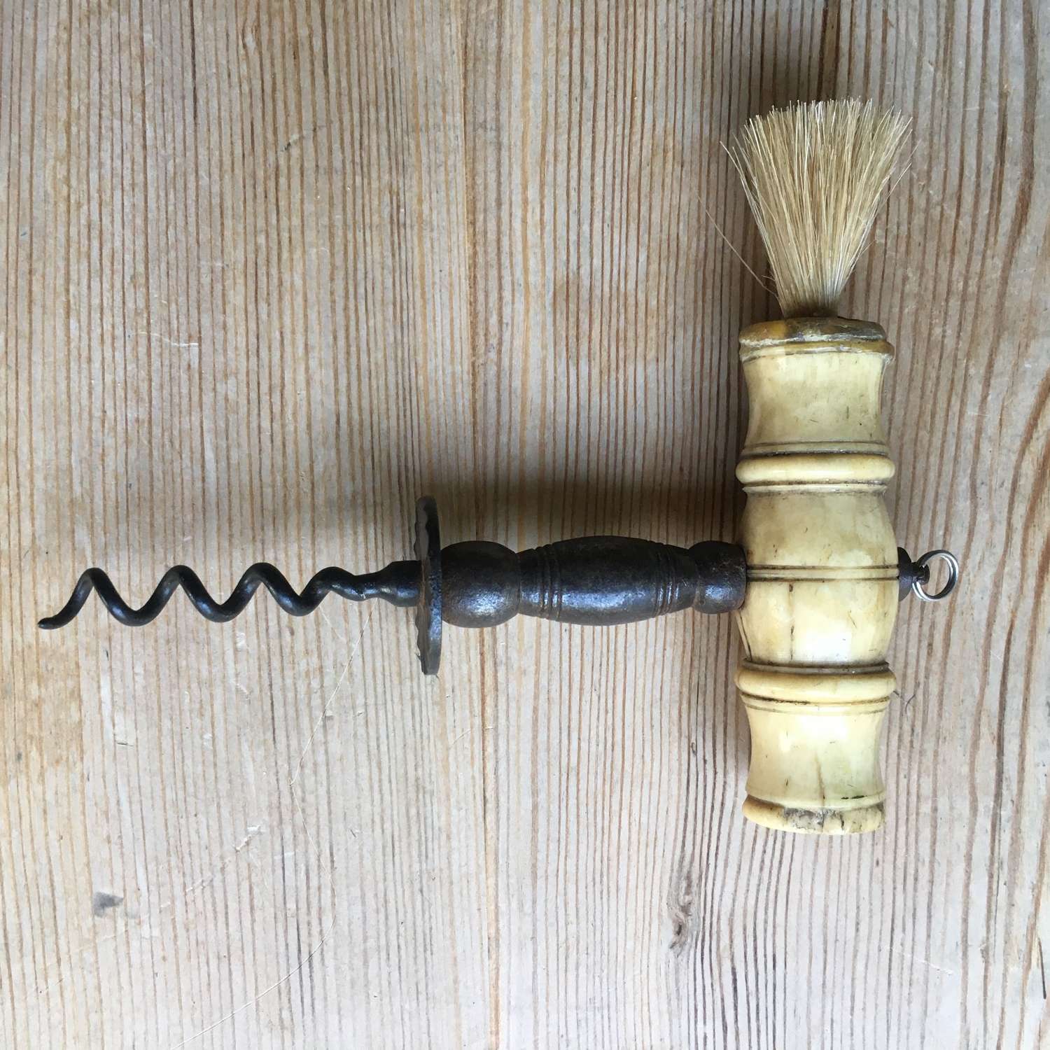Corkscrew of Henshall type with bone handle and brush