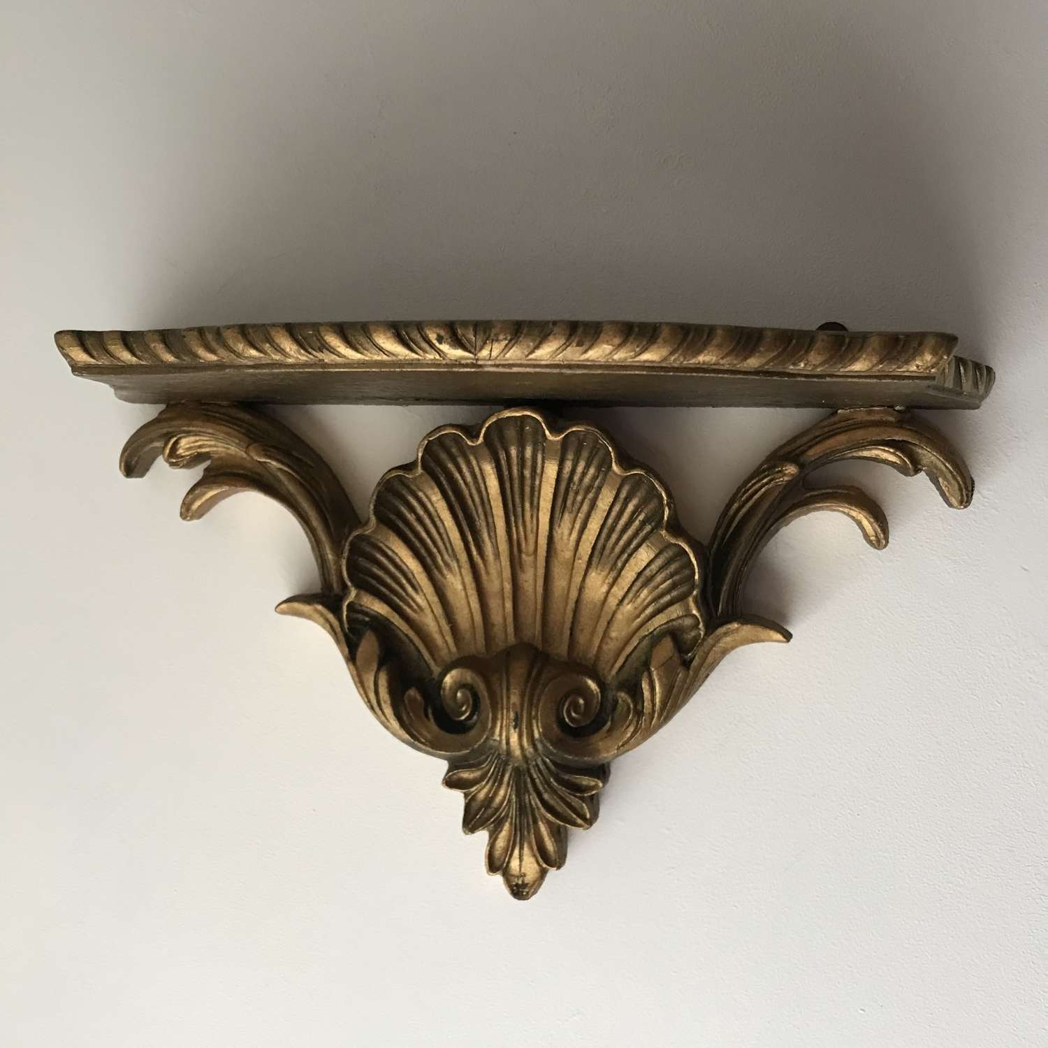 1930’s gilded shell shaped wall shelf.