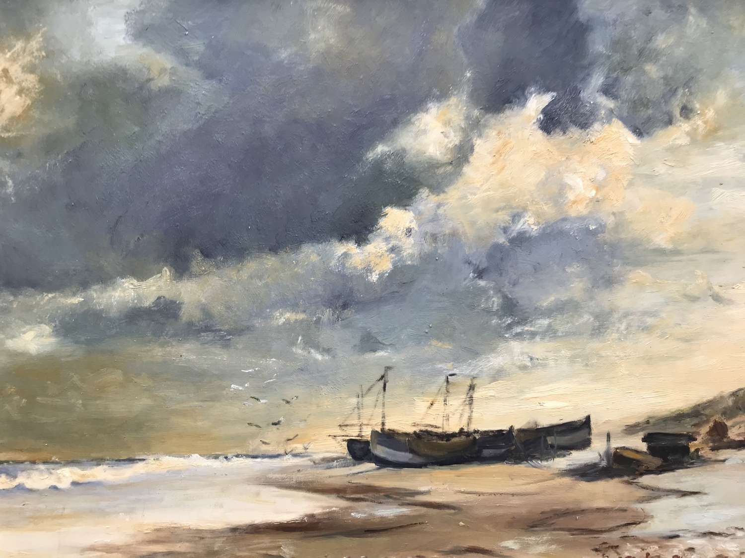 Oil on board of fishing boats on a beach
