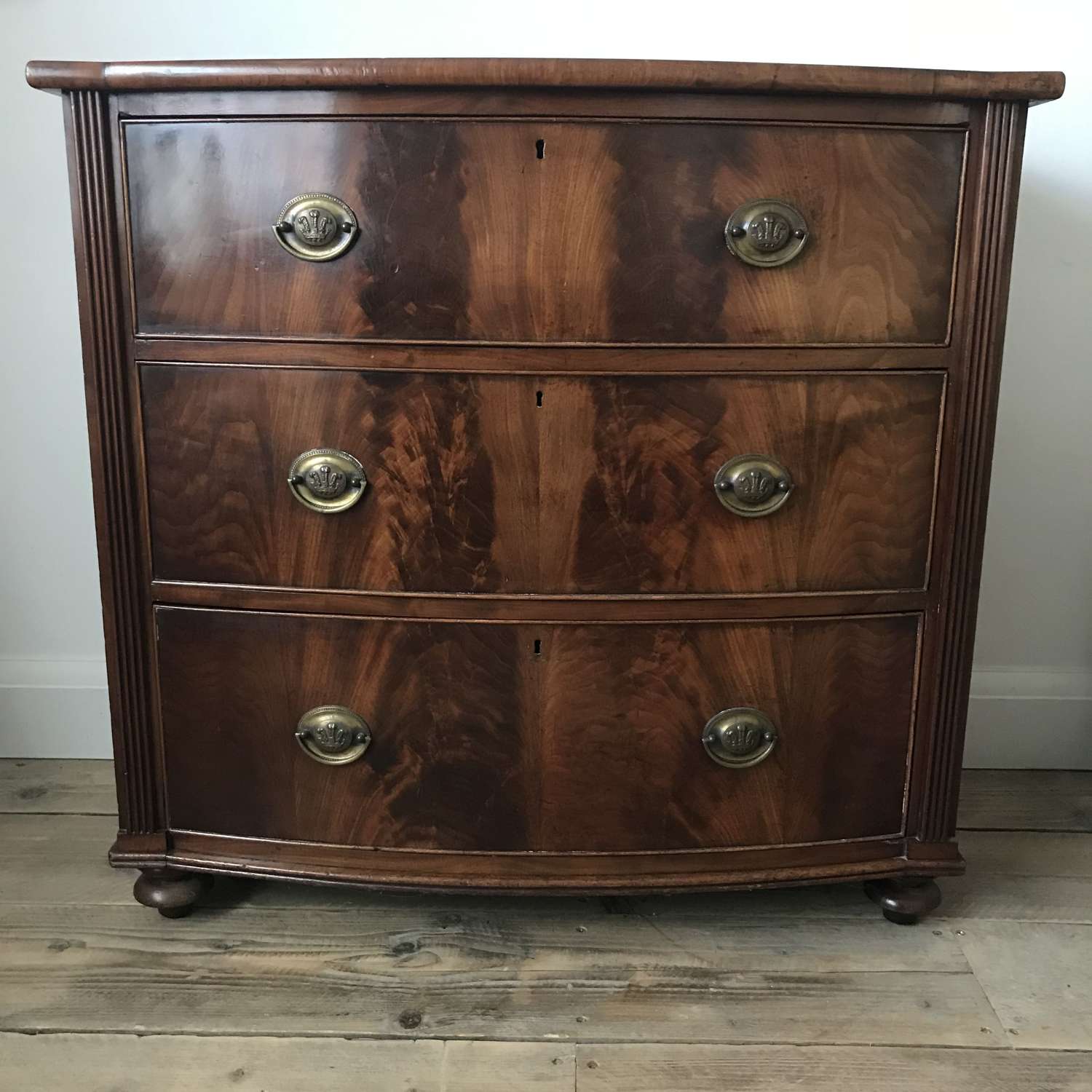 Early 19th century bow front flame mahogany chest of drawers