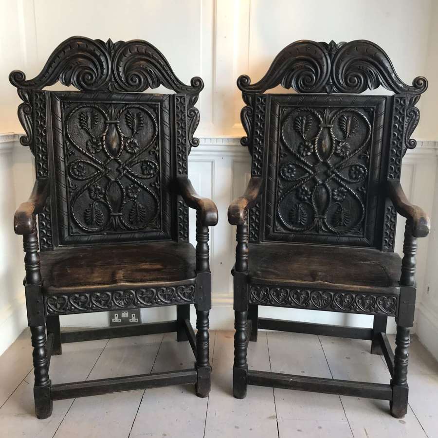 A pair of carved wainscot chairs